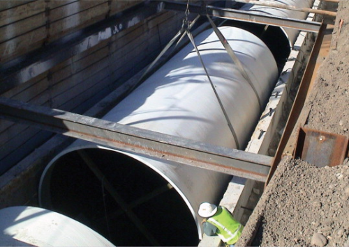 Denver sewer pipe installed in bottom portion of concrete culvert.