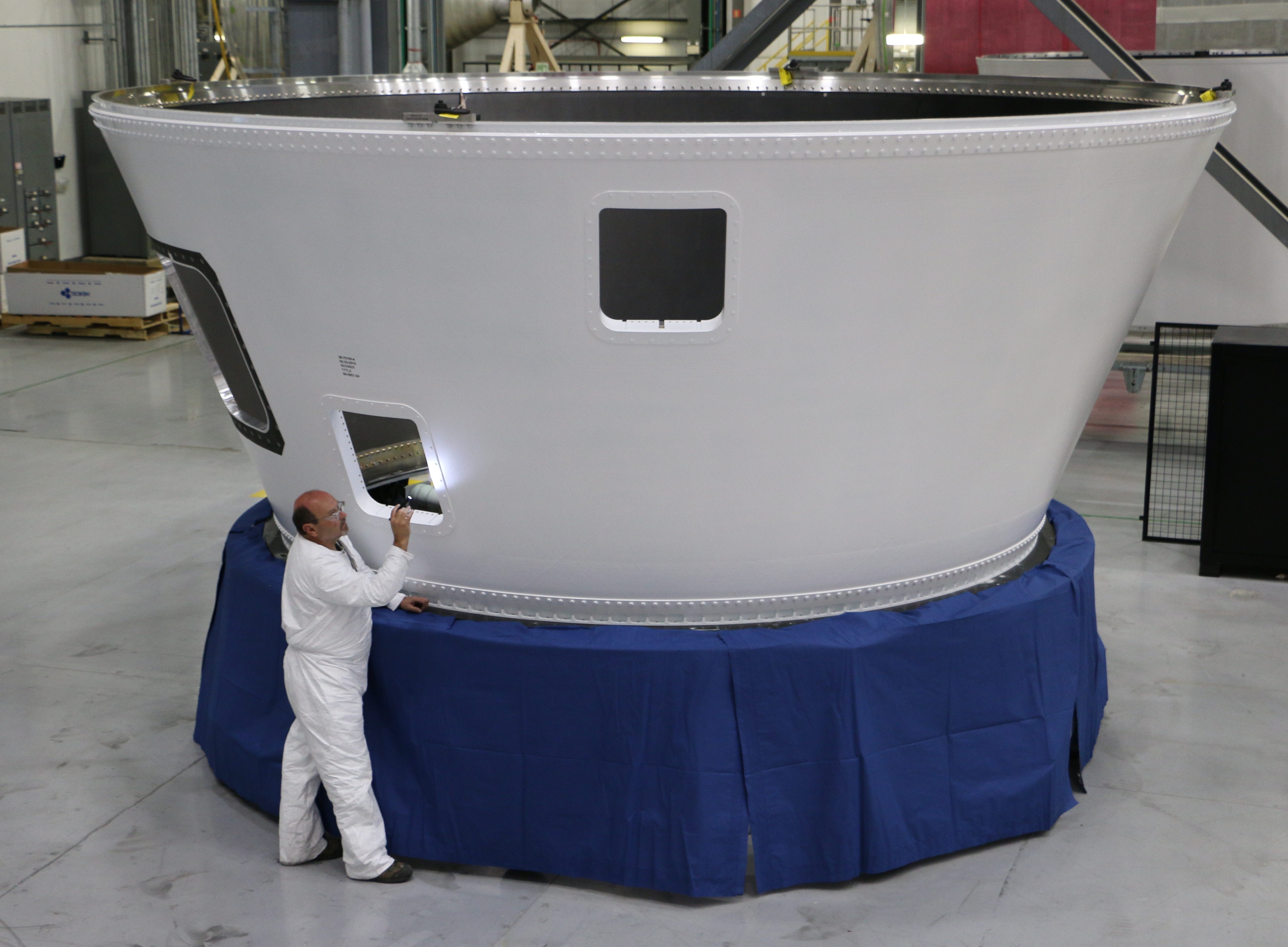 An Orbital ATK employee inspects an Atlas V boat tail, the 500th large composite rocket structure produced at the company's Iuka, Mississippi, facility for United Launch Alliance launch vehicles. (Photo: Business Wire)