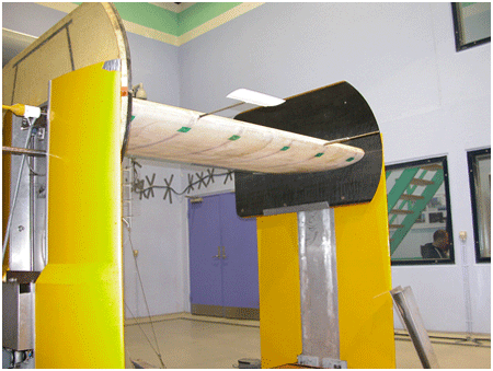 The photograph shows the two sensors for measuring wind speed and direction. The nearest sensor resembles a small blade, and by measuring the wind load on the sensor, a control signal can be derived and sent to the rubber trailing edge. The other sensor is a so-called five-hole pitot tube, which can measure wind speed and wind direction, and which can also be used to control the rubber trailing edge.