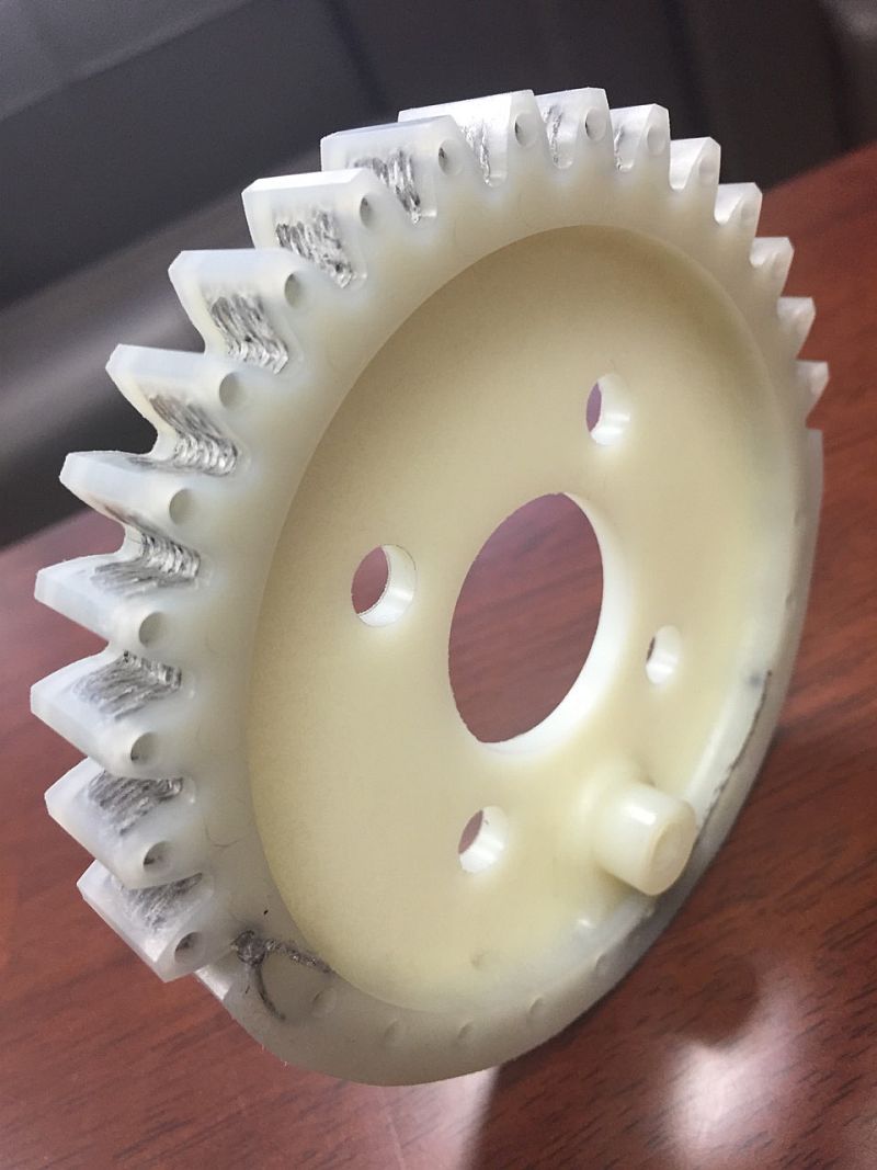 The plastic gear wheel reinforced with carbon fiber fabric.