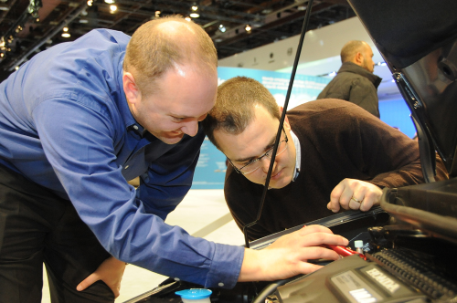Automotive engineers pore over new vehicles on display at the North American International Auto Show in Detroit. In the engine compartment, metals are being replaced by new composite materials that can take the heat.