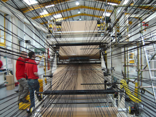 Tows of UD reinforcements are fed into machinery in the prepreg production process at this ACG facility.