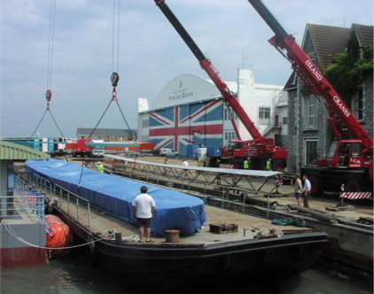 Completed moulds being embarked onto a barge at Cowes, Venture Quays, for onward transportation.