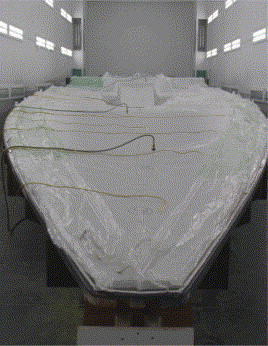 The deck was vacuum bagged and cooked under the same cure regime as the hull. The yellow leads are to the thermocouples and the green lines are to vacuum ports. (Picture courtesy of Killian Bushe and Andrew Lowe.)