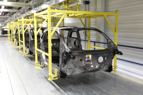 The i3 is produced at BMW's Leizig plant. This picture shows the CFRP body, which is subsequently surrounded by a thermoplastic outer skin and a roof made of recycled CFRP. (Picture © BMW Group.)