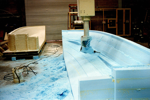 Foam is machined using a 5-axis CNC router for a direct-to-mould boat hull project at Mollicam.