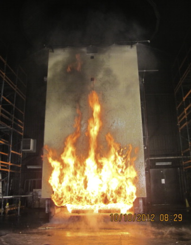 3 MW façade fire test on a large composite surface, well protected by a water spray on top. The only thing burning in the picture is a diesel tray below the surface. From BESST project. Photo used with permission © SP Technical Research Institute of Sweden.