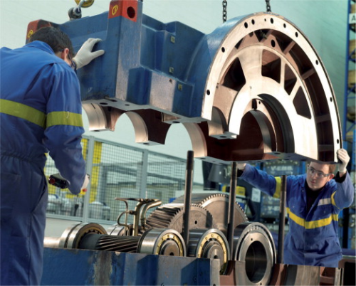 Engineers putting the housing onto a gear box: gearbox failures can result in high repair costs plus lost revenue due to unplanned downtime (image courtesy of ZF).