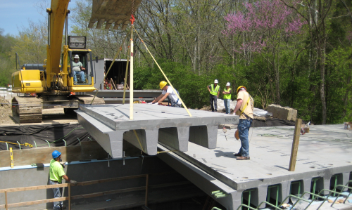 In addition to lighter weight, corrosion resistance, higher strength and lower life cycle costs, FRP technology offers faster installation. Prefabricated FRP panels can be installed quickly, compared to the labour intensive process of erecting formwork, placing rebar, pouring and curing concrete, and removing the formwork needed to construct a cast-in-place bridge.  Eliminating the need for heavy equipment, FRP panels are generally placed starting at one abutment with light equipment such as an excavator.