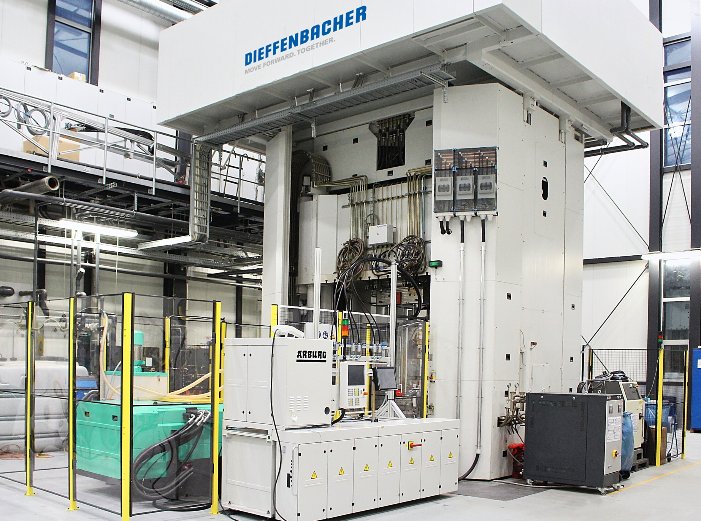The Dieffenbacher transfer molding press plus an FDC injection unit from Arburg. (Photo courtesy Dieffenbacher.)