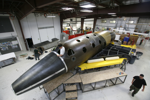 SpaceShipTwo is seen during the construction phase at the facilities of Scaled Composites. Like its mothership, this 60-ft-long (18.3 m) spacecraft was constructed of carbon fibre composites for high strength and weight savings. It will be powered by a hybrid rocket motor, currently under construction.