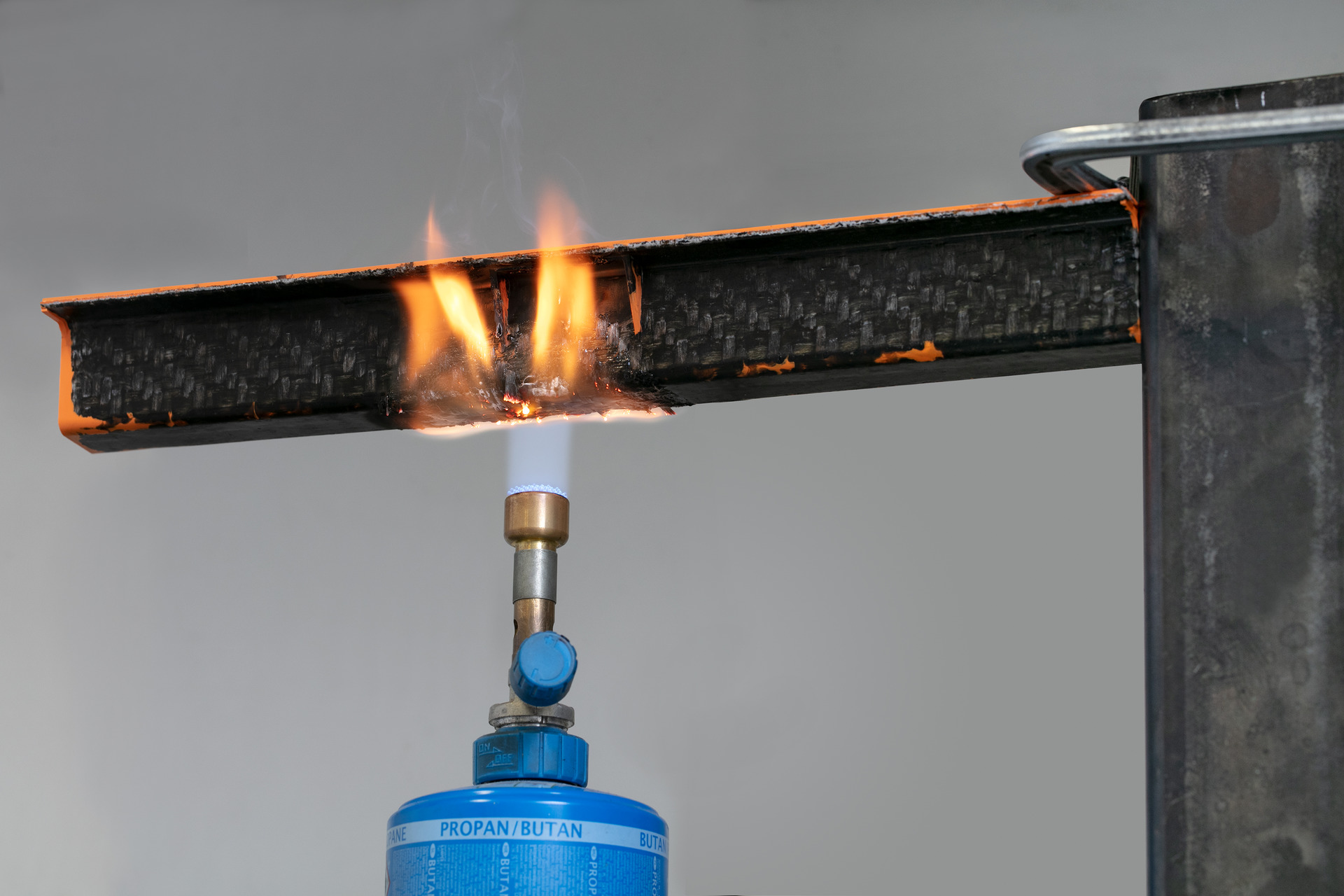 A black carrier profile made with of one of the new Tepex grades, the rib structure of an orange, halogen-free flame-retardant polyamide 6 Durethan. The flames extinguish when the burner is removed. (Photo courtesy Lanxess AG.)