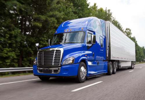 Daimler’s North America Blue cabin Cascadia truck on the road.
