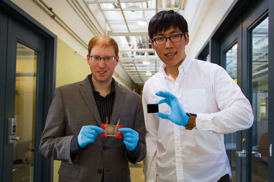 Jeonyoon Lee (right) holds an aligned carbon nanotube array, and Itai Y Stein (left) holds the resulting aligned carbon nanotube film microheater.