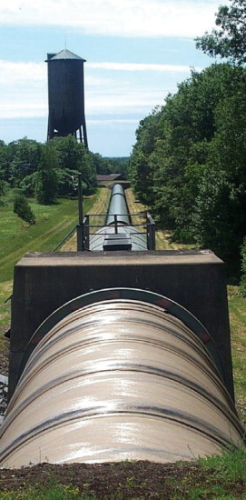 Figure 8: A down-gradient picture along a buried section of the pipe, showing where the FRP connects into a steel pipe.
