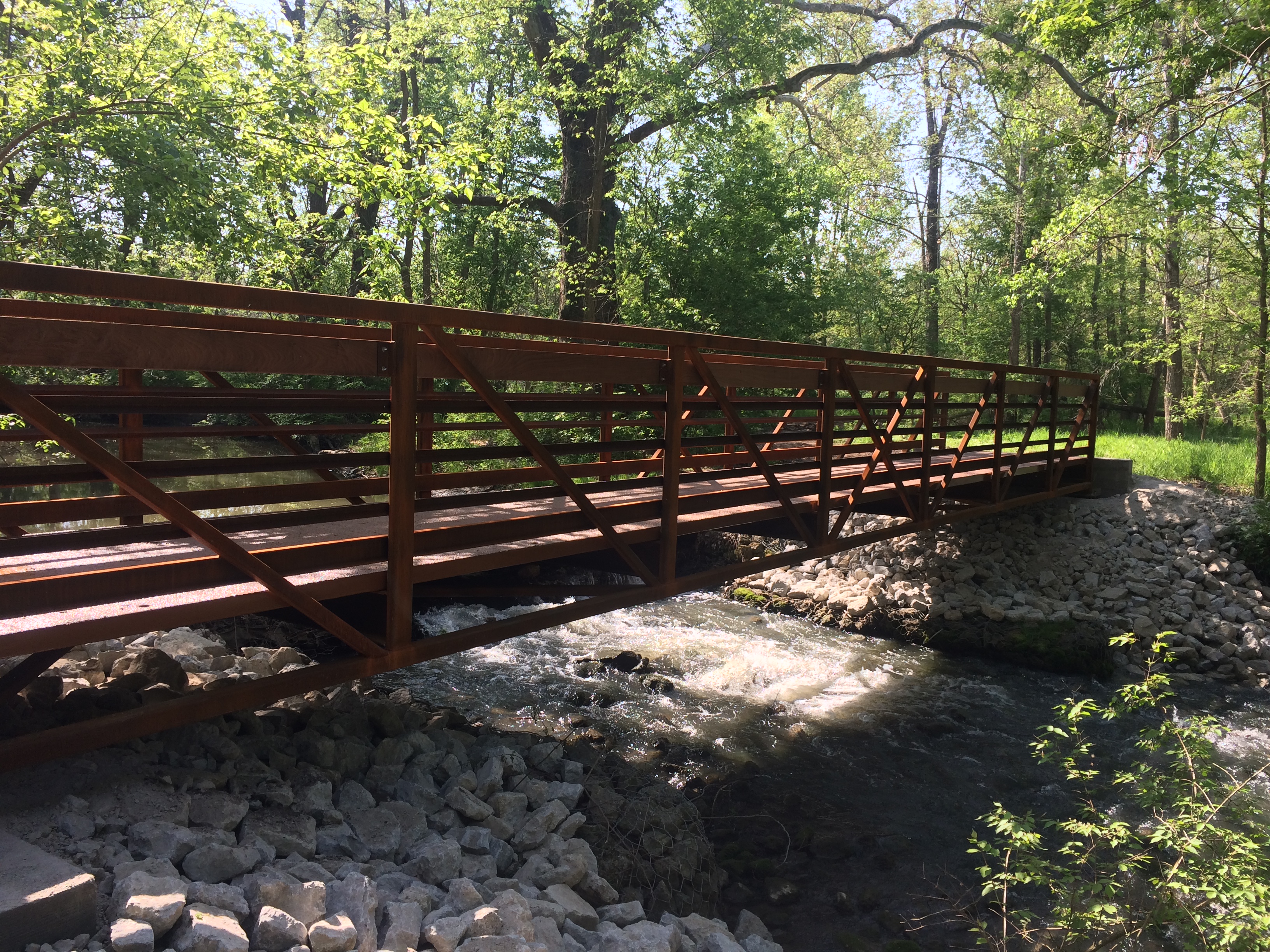 The company specified a weathered steel truss 45 ft superstructure along with two large, three ½ inch thick, six ft wide molded FRP bridge deck panels with black pigment.