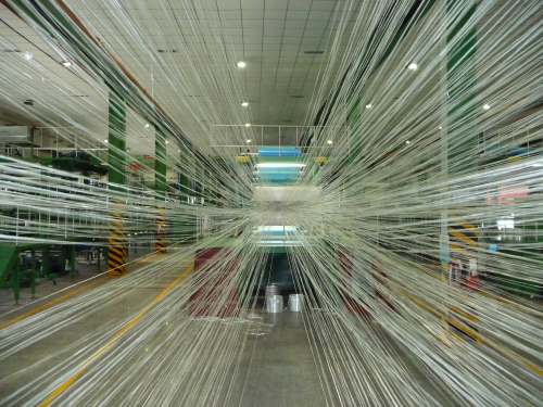 Glass roving being processed into unidirectional prepreg for the wind energy market at Guang Wei Composites' facility.