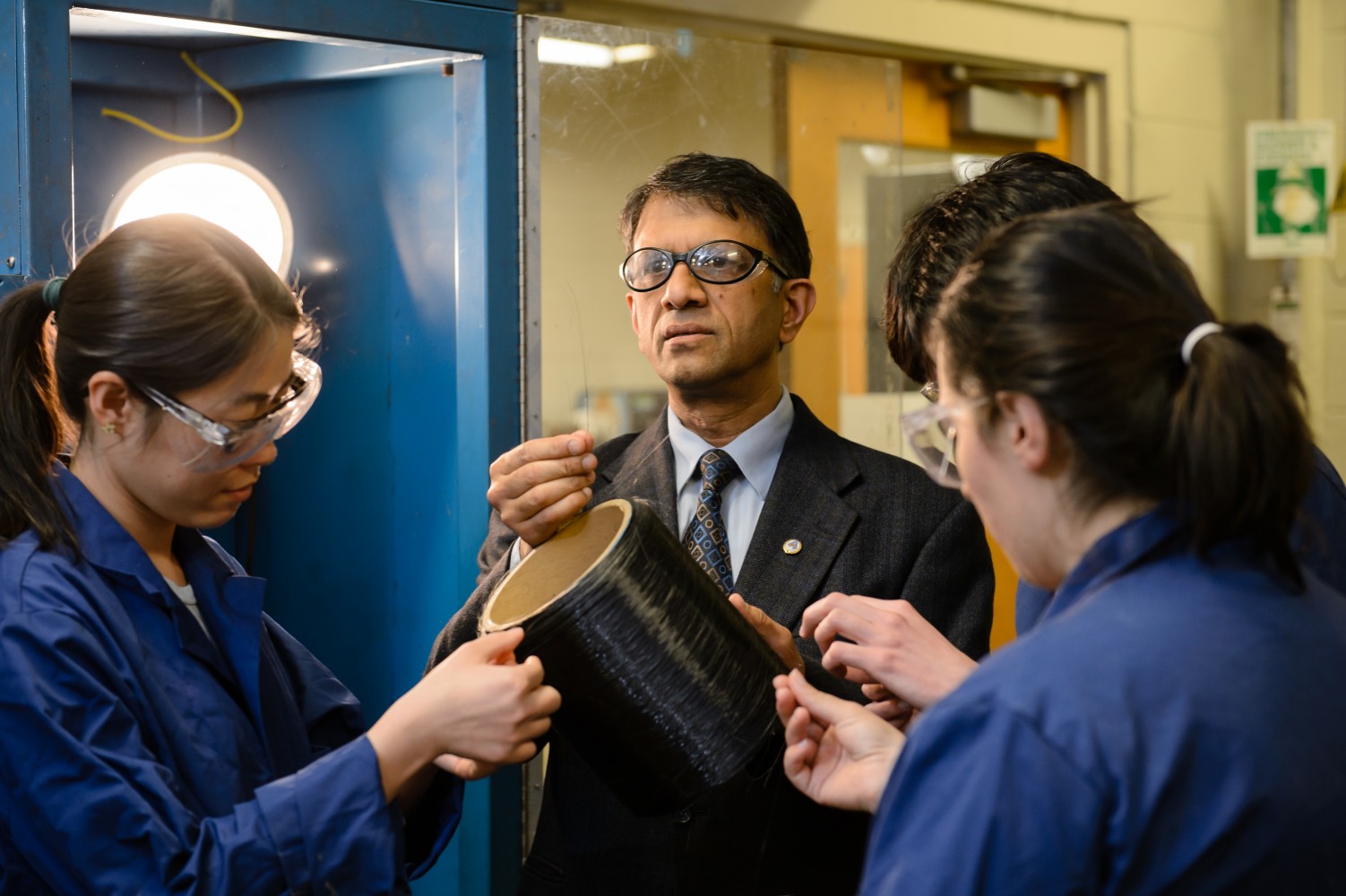 Amod Ogale inspects some carbon fiber with his team in their Earle Hall lab.