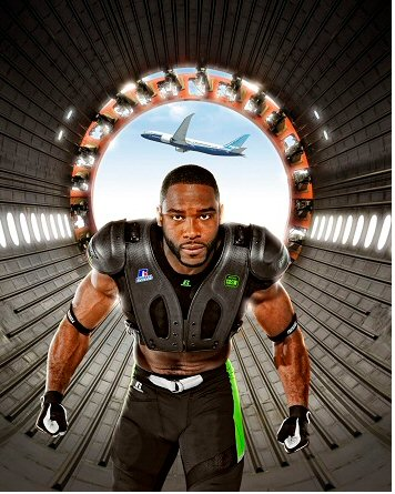 Russell Athletic brand ambassador and pro football wide receiver Pierre Garcon wears the CarbonTek shoulder pad system, with an exosketon made of 787 carbon fibre. He is shown inside a 787 Dreamliner carbon composite fuselage.