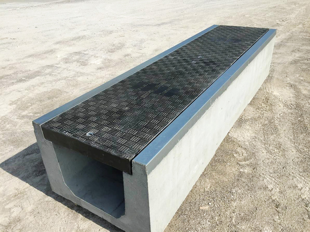 Fibrelite and Trenwa’s partnership product: heavy duty precast concrete trenches topped with light strong composite covers.